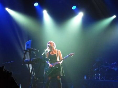 woman playing guitar on stage